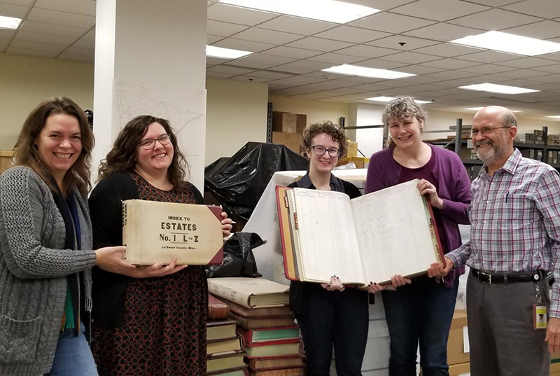 team members holding an old directory