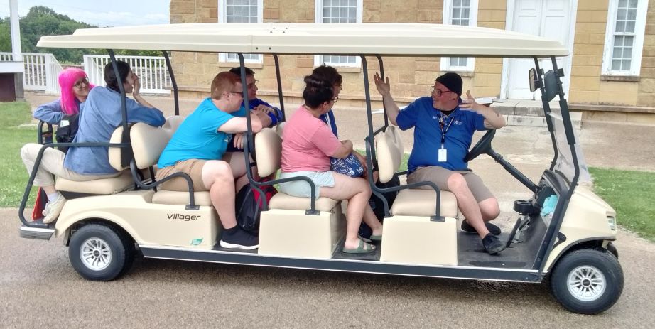folks on a golf cart at Historic Fort Snelling