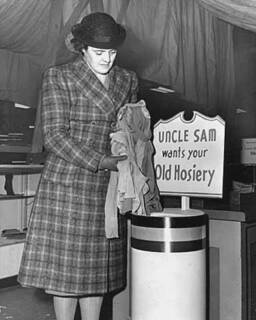 nn Ginn of the War Production Board Salvage Committee donating hosiery for defense.