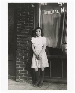 Oy Huie in front of Sang Yuen General Merchandise, Minneapolis