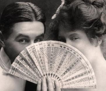 two Victorians flirting from behind a fan
